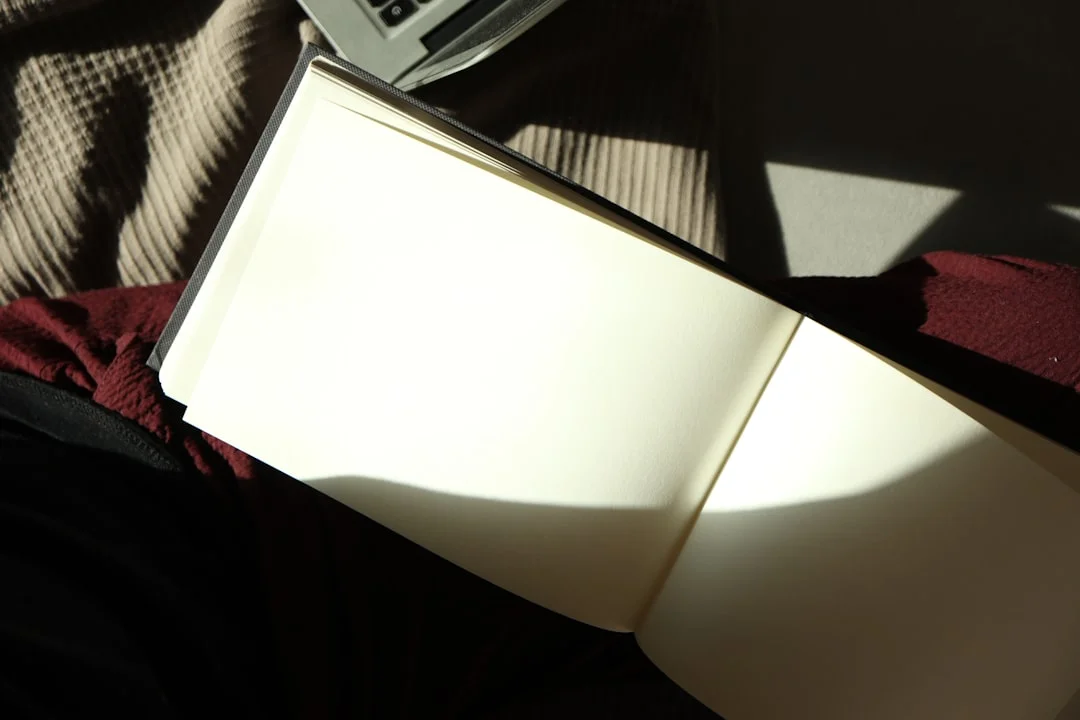 A journal and pen on a sunlit table, set up for quiet self-reflection