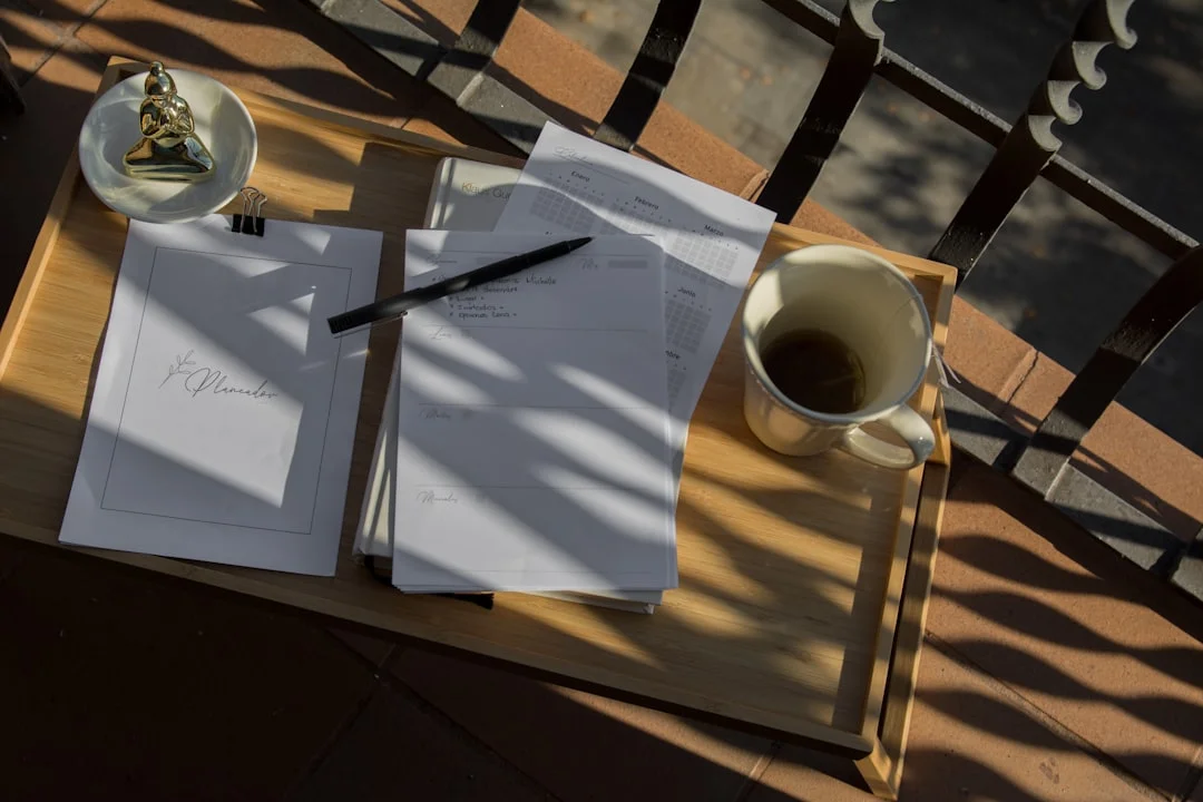 A journal and coffee on a sunlit desk, ready for a morning writing routine