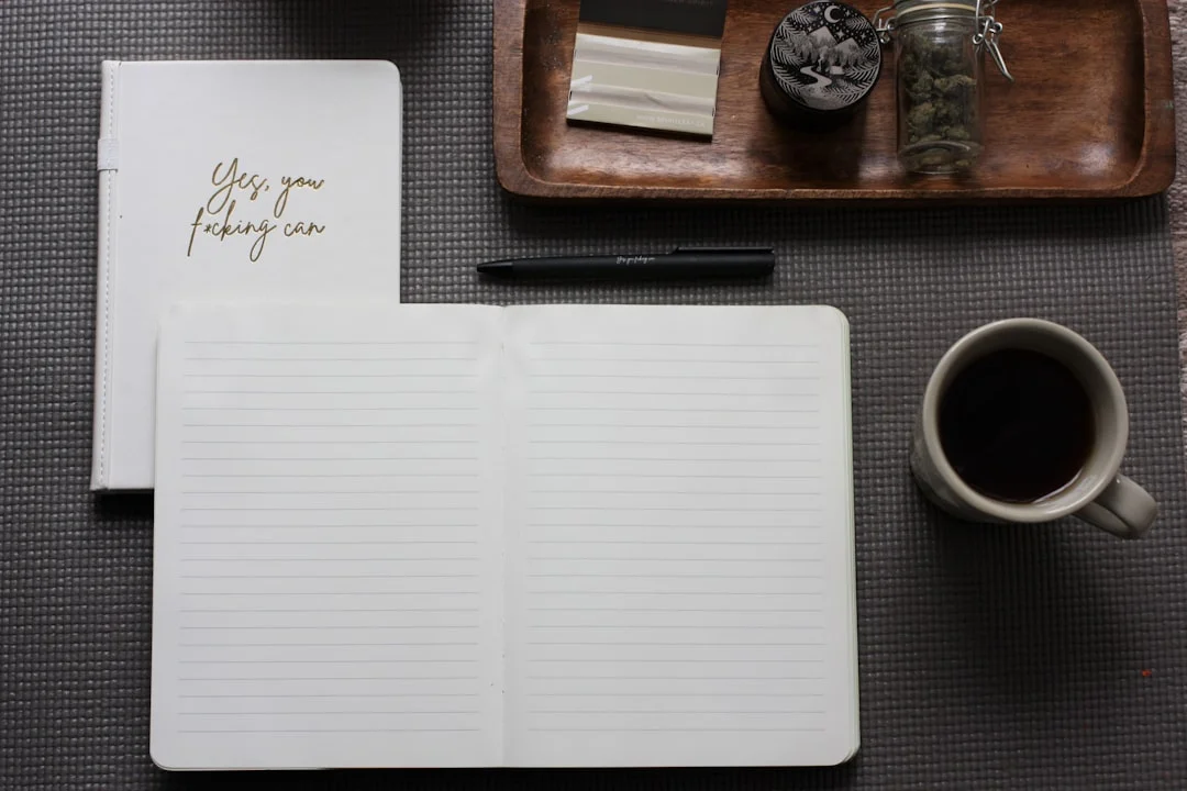A calm desk with an open journal, pen, and a cup of tea, ready for therapy journaling